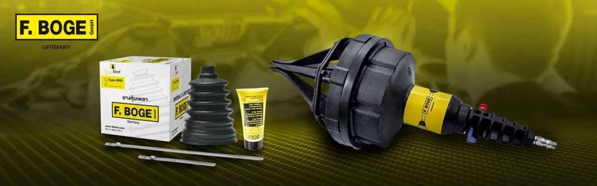 F. BOGE Germany car repair kit displayed with a boxed box, rubber CV boot, tube of lubricant, clamps, and a large wheel hub or tool laid out on a yellow gradient background